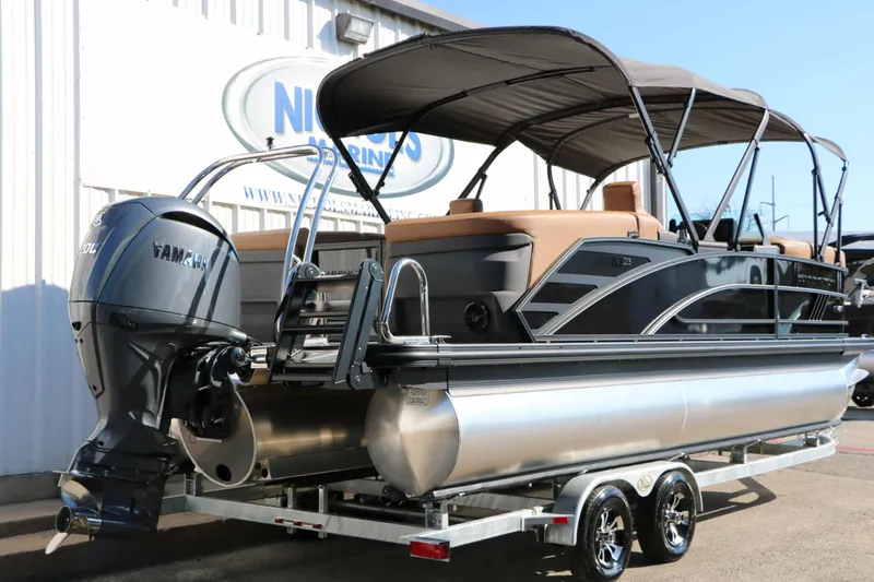 Slide: The Image of A 2027 Bennington 23 MFB Tri Toon with a Yamaha outboard motor, on a trailer. - 21