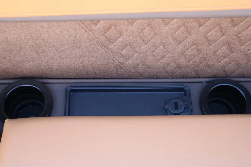 Slide: The Image of Close-up of a seating area with two cup holders and a small storage compartment. - 41