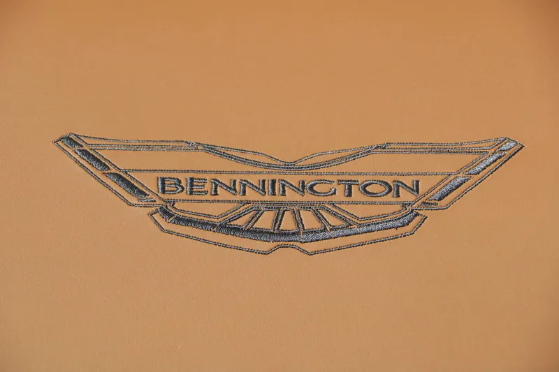 Slide: The Image of Bennington logo on a brown background, possibly part of a boat seat or upholstery. - 40
