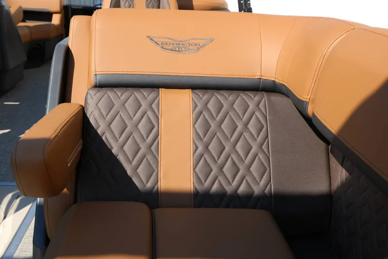 Slide: The Image of Luxurious brown and gray upholstery with quilted pattern and Bennington logo on a boat seat. - 38