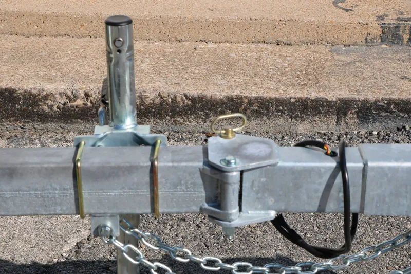 Slide: The Image of Close-up of a boat trailer with metal hitch and safety chains. - 33