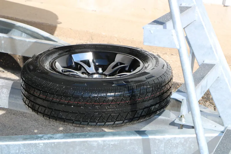 Slide: The Image of A spare tire is mounted on a boat trailer. - 34