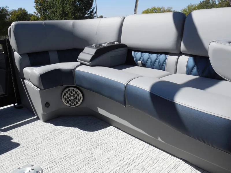 Slide: The Image of The Bennington 25 QXFBA 2027 features luxurious seating with cushioned seats and built-in speakers. - 28