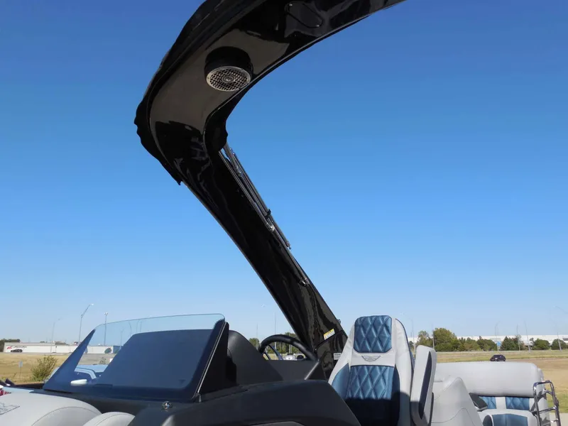 Slide: The Image of The image shows the cockpit of a 2027 Bennington 25 QXFBA with blue seats and a black Bimini top. - 29