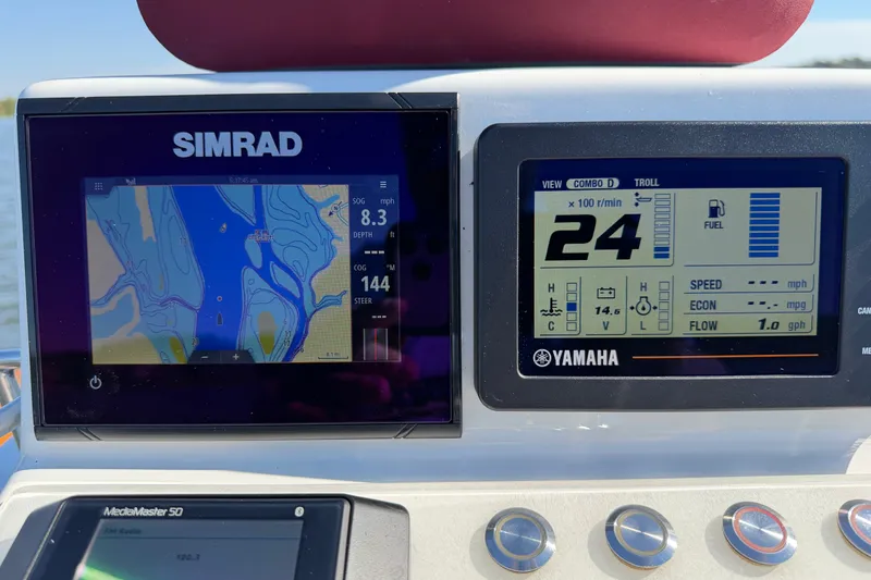 Slide: The Image of Simrad and Yamaha displays on 2019 Caribiana Maracas 23 Skiff dashboard, showing navigation and engine data. - 7