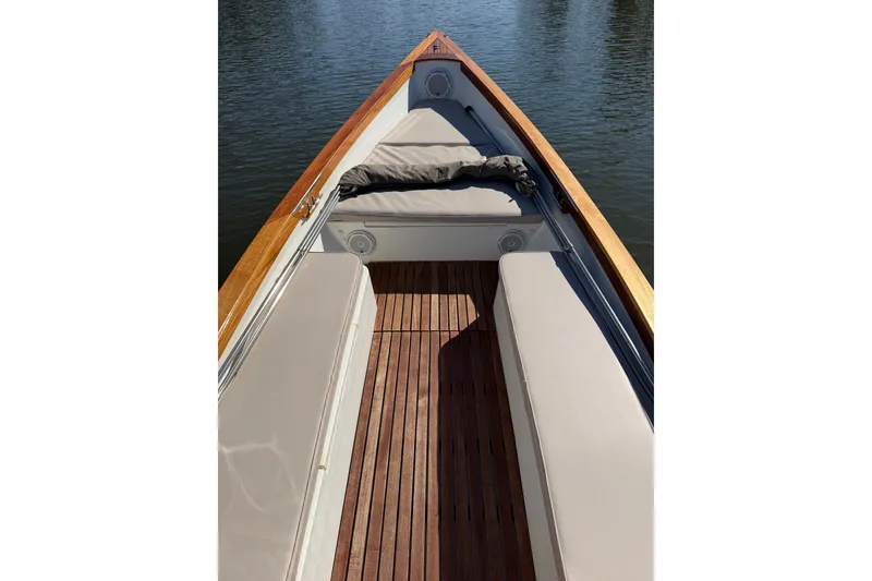 Slide: The Image of 2019 Caribiana Maracas 23 Skiff interior with wooden deck and cushioned seating. - 5