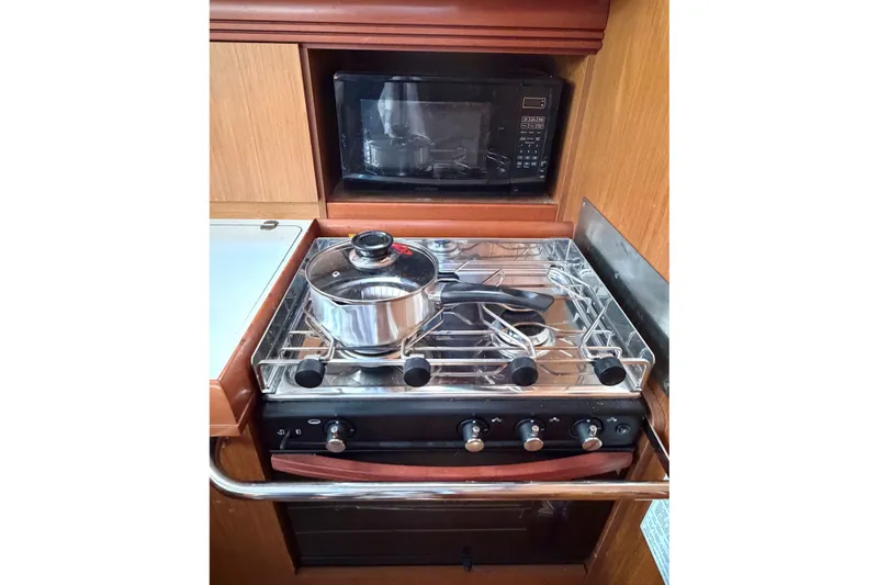Slide: The Image of Galley kitchen in 2007 Jeanneau Sun Odyssey 42 DS with stove and microwave. - 14