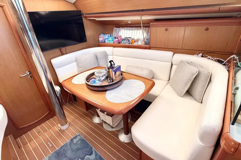 Slide: The Image of Interior of 2007 Jeanneau Sun Odyssey 42 DS yacht with cozy seating and wooden table. - 12