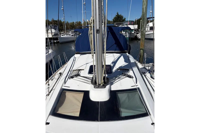Slide: The Image of 2007 Jeanneau Sun Odyssey 42 DS sailboat docked in a marina, showcasing deck and mast. - 6