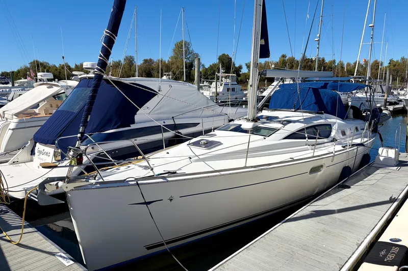 Slide: The Image of 2007 Jeanneau Sun Odyssey 42 DS sailboat docked at a marina under clear blue skies. - 2