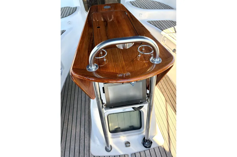 Slide: The Image of Cockpit table on 2007 Jeanneau Sun Odyssey 42 DS sailboat with polished wood finish. - 5