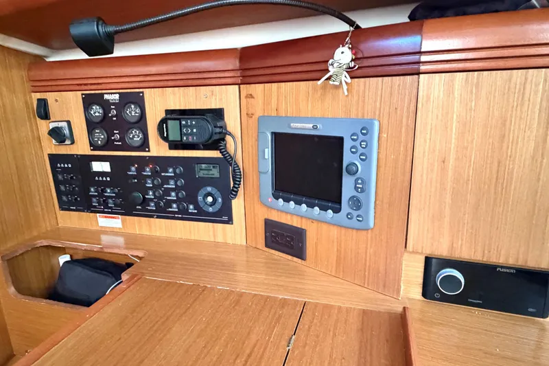 Slide: The Image of Control panel of a 2007 Jeanneau Sun Odyssey 42 DS sailboat, featuring navigation and communication equipment. - 15