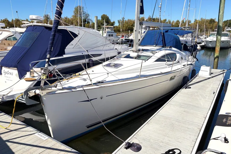 Slide: The Image of 2007 Jeanneau Sun Odyssey 42 DS sailboat docked at a marina, surrounded by other boats. - 22