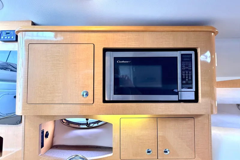 Slide: The Image of 2009 Four Winns 278 Vista interior with microwave and wooden cabinetry. - 21