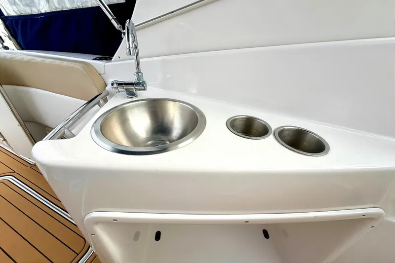 Slide: The Image of 2009 Four Winns 278 Vista boat sink and cup holders on deck. - 16