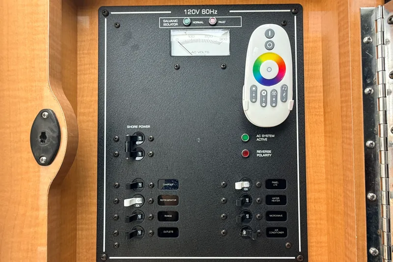 Slide: The Image of Electrical panel of a 2009 Four Winns 278 Vista boat with control switches and remote. - 31