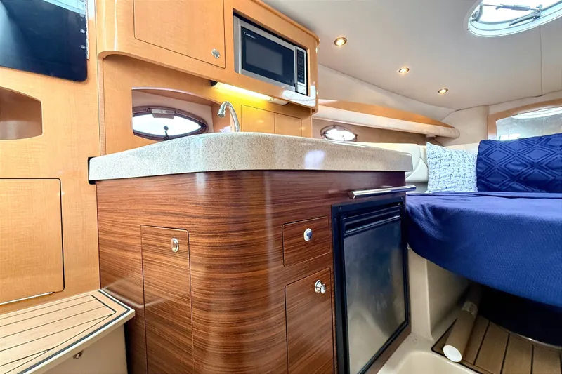 Slide: The Image of Interior of 2009 Four Winns 278 Vista boat with kitchenette and seating area. - 20