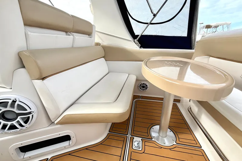 Slide: The Image of 2009 Four Winns 278 Vista boat interior with beige seating and round table. - 13