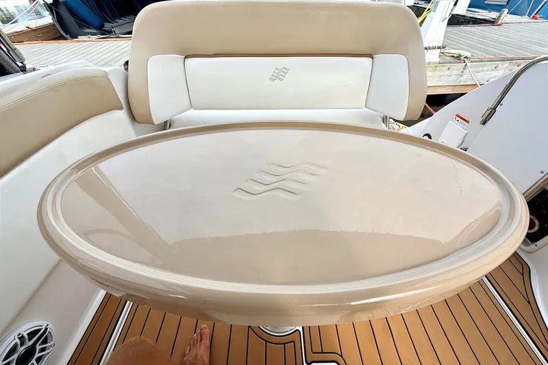 Slide: The Image of 2009 Four Winns 278 Vista boat interior with oval table and cushioned seating. - 14