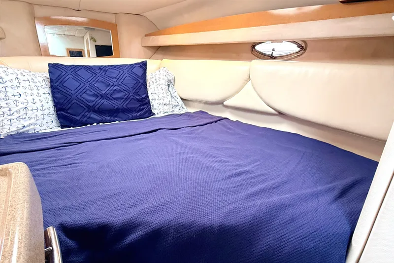 Slide: The Image of Cozy cabin interior of 2009 Four Winns 278 Vista with blue bedding and nautical decor. - 23