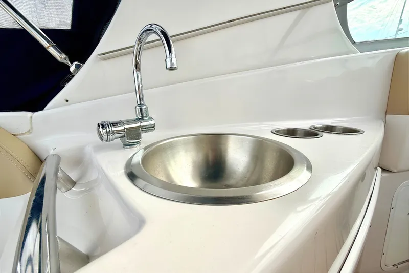 Slide: The Image of 2009 Four Winns 278 Vista boat sink with chrome faucet and cup holders. - 17