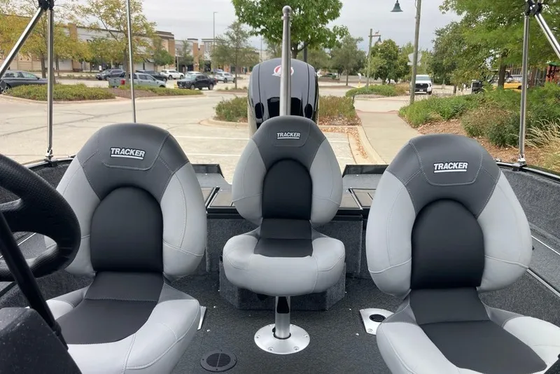 Slide: The Image of 2027 Tracker Targa V-18 Combo boat interior with three gray and black seats. - 60