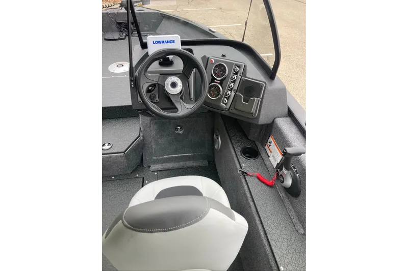 Slide: The Image of 2027 Tracker Targa V-18 Combo boat cockpit with steering wheel and control panel. - 58