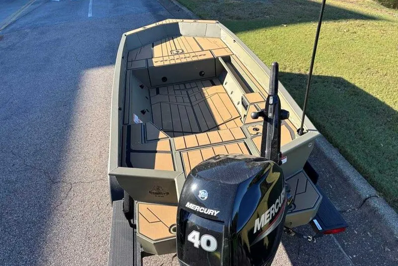 Slide: The Image of 2027 Tracker Grizzly 1553 Timber boat with Mercury 40 engine on a road. - 14