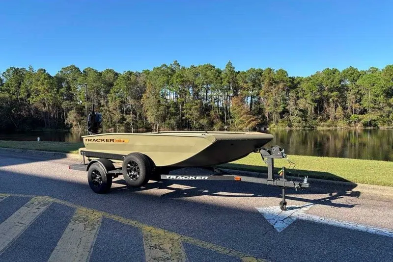 Slide: The Image of 2027 Tracker Grizzly 1553 Timber boat on trailer by a scenic lake. - 15