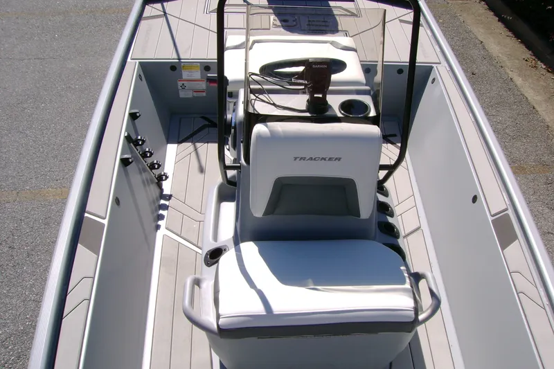 Slide: The Image of 2027 Tracker Bass Tracker Classic CC boat interior with steering console and seating. - 13