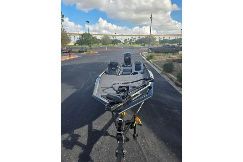 Slide: The Image of 2027 Tracker Pro Team 190 boat in parking lot under cloudy sky. - 14