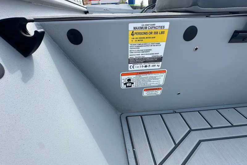 Slide: The Image of 2027 Tracker Bass Tracker 175 CC boat capacity label, showing maximum capacity of 4 persons or 555 lbs. - 26