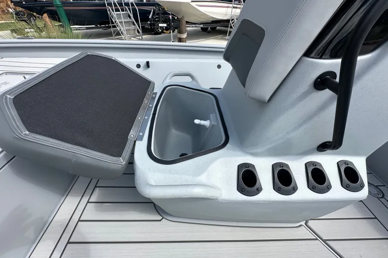 Slide: The Image of 2027 Tracker Bass Tracker 175 CC boat interior with storage compartment and rod holders. - 22