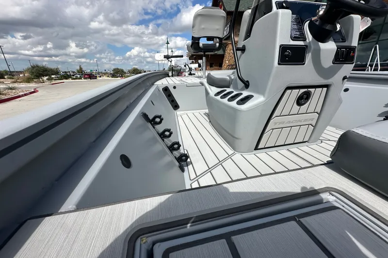 Slide: The Image of 2027 Tracker Bass Tracker 175 CC boat interior with steering console and rod holders. - 18