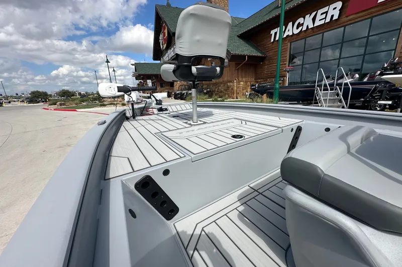 Slide: The Image of 2027 Tracker Bass Tracker 175 CC boat displayed outside a dealership under a cloudy sky. - 20