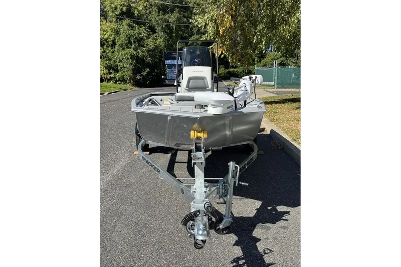 Slide: The Image of 2027 Tracker Bass Tracker Classic CC boat on trailer, parked on a sunny street. - 17