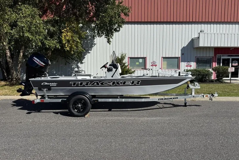 Slide: The Image of 2027 Tracker Bass Tracker Classic CC boat on trailer, parked outdoors. - 15