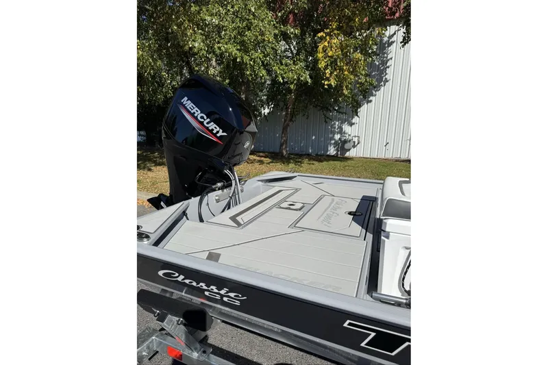 Slide: The Image of 2027 Tracker Bass Tracker Classic CC boat with Mercury engine, parked outdoors. - 22
