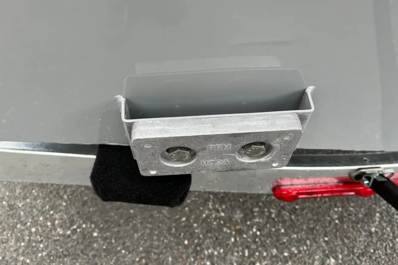 Slide: The Image of 2027 Tracker Bass Tracker Classic CC boat detail with metal bracket and trailer light. - 14