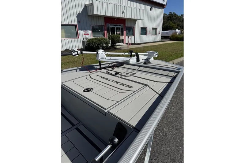Slide: The Image of 2027 Tracker Bass Tracker Classic CC boat with trolling motor, parked outside a building. - 21