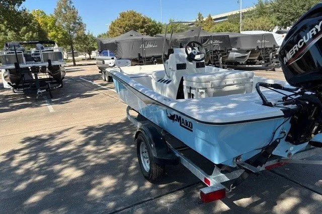 Slide: The Image of 2027 Mako Pro Skiff 15 CC boat on trailer in sunny parking lot. - 6