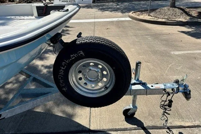 Slide: The Image of Trailer hitch and spare tire of a 2027 Mako Pro Skiff 15 CC boat. - 14