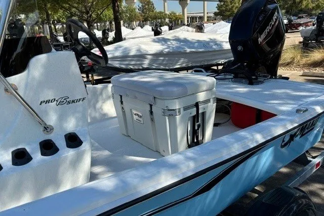 Slide: The Image of 2027 Mako Pro Skiff 15 CC boat with cooler and Mercury engine. - 12