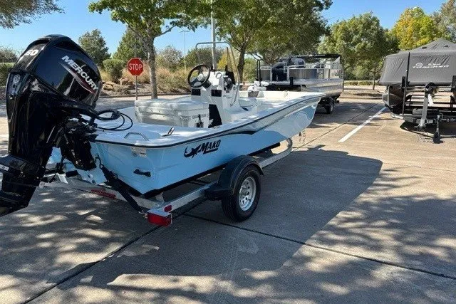 Slide: The Image of 2027 Mako Pro Skiff 15 CC boat on trailer in sunny parking lot. - 7