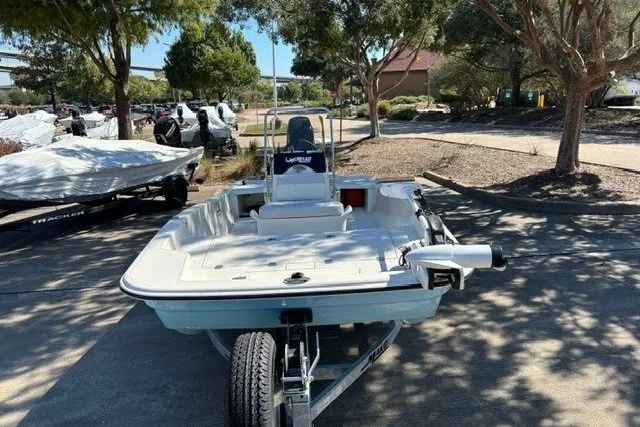 Slide: The Image of 2027 Mako Pro Skiff 15 CC boat on trailer in outdoor setting. - 5