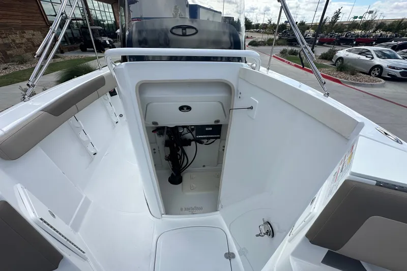 Slide: The Image of 2027 Tahoe 2150 CC boat interior with open storage compartment and seating area. - 21