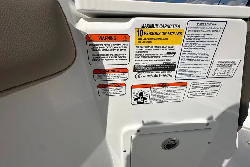 Slide: The Image of Warning labels and capacity information on a 2027 Tahoe 2150 CC boat. - 24