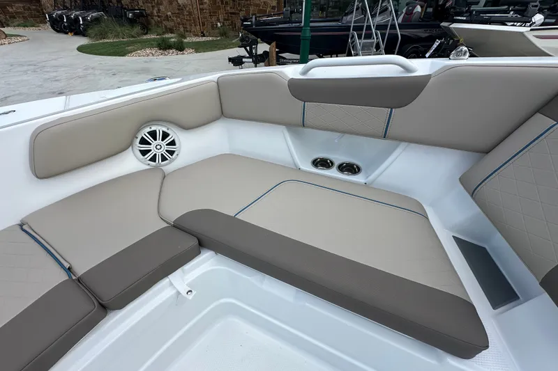 Slide: The Image of 2027 Tahoe 2150 CC boat interior with beige seating and built-in speaker. - 19