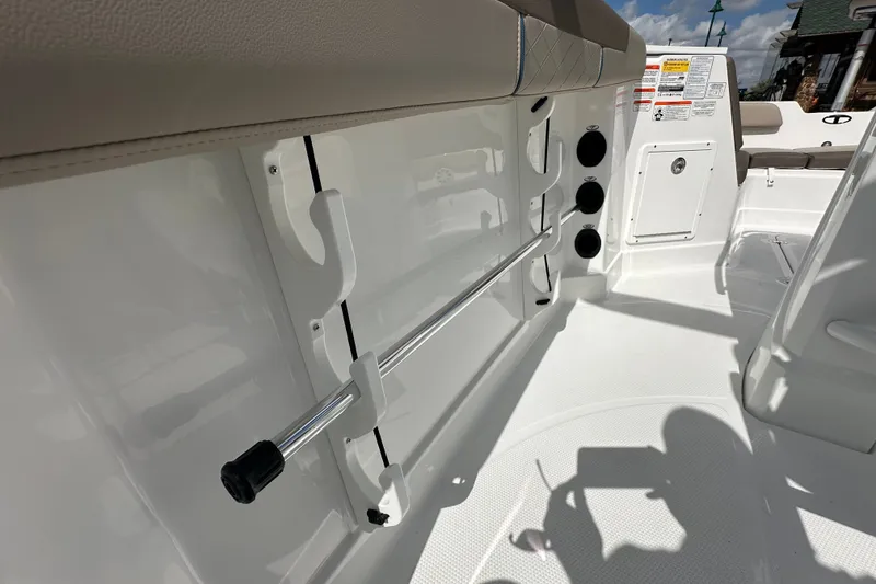 Slide: The Image of Interior view of 2027 Tahoe 2150 CC boat, featuring rod holders and seating area. - 25