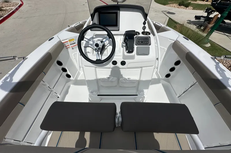 Slide: The Image of 2027 Tahoe 2150 CC boat interior with steering wheel and control panel. - 15